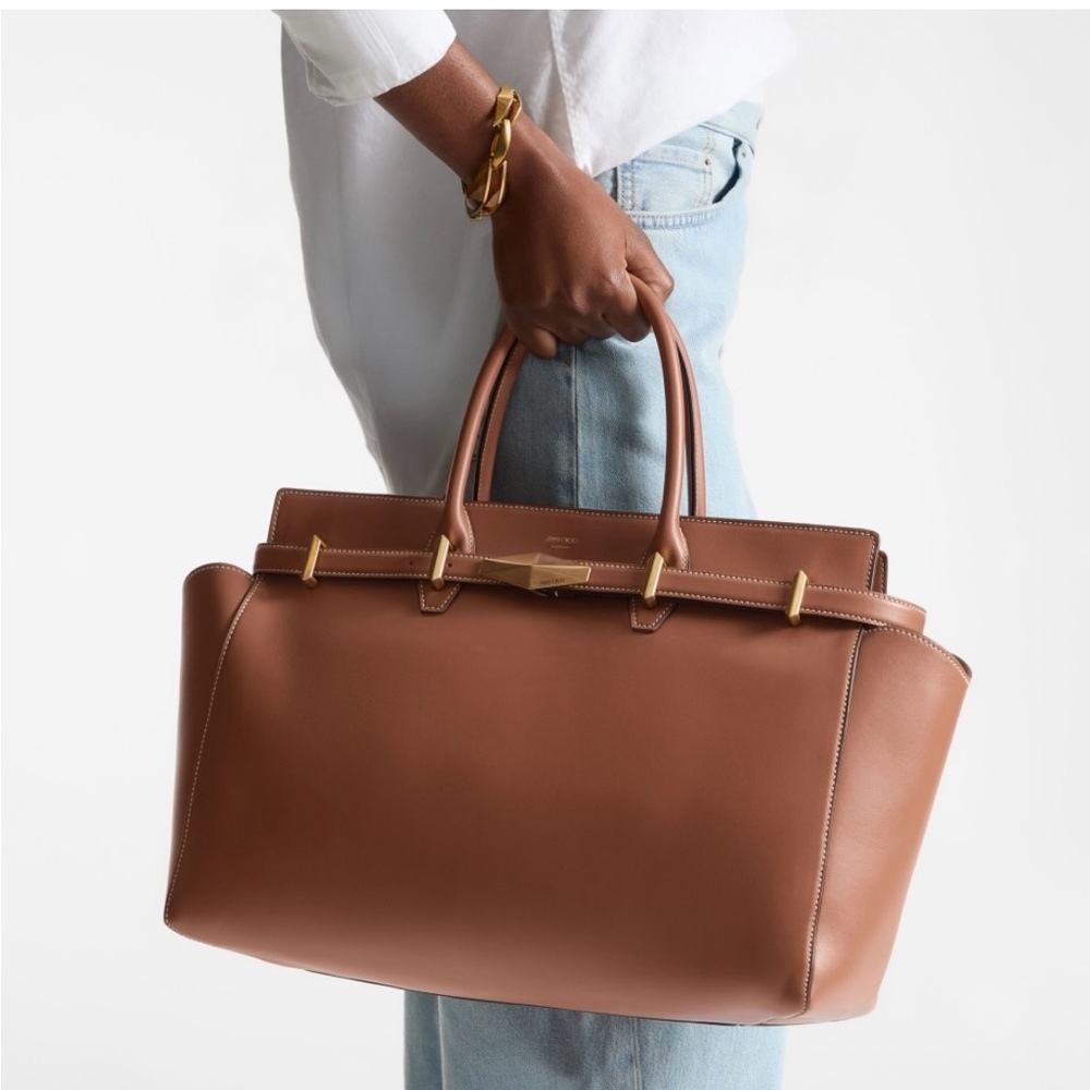 Model carrying the Jimmy Choo Diamond handbag by its top handles