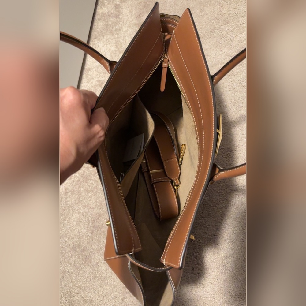 Inside the actual purse showing the leather lining and shoulder strap